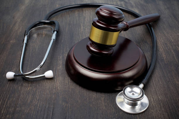 istock Gavel and stethoscope on black wooden background 1154753836