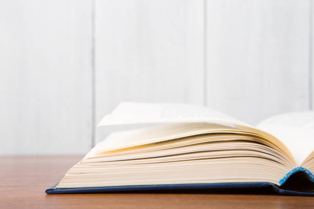 istock Open book on the desk over wooden background 1154754148