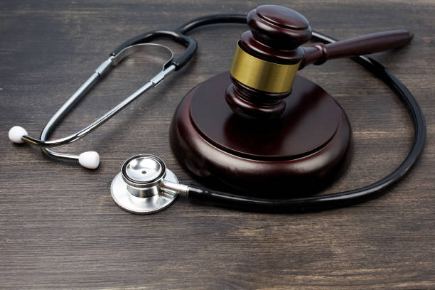 istock Gavel and stethoscope on black wooden background 1154754295