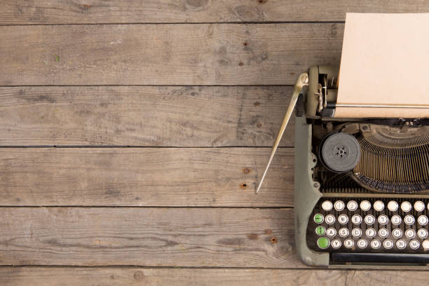 istock Vintage typewriter on the old wooden desk 1154754999