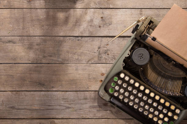 istock Vintage typewriter on the old wooden desk 1154755052