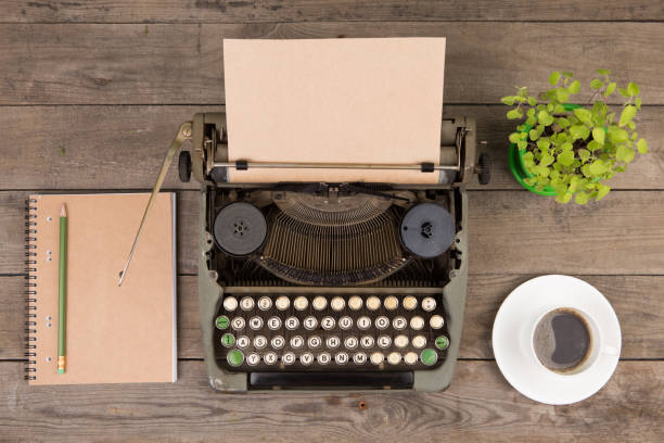 istock Vintage typewriter on the old wooden desk 1154755062