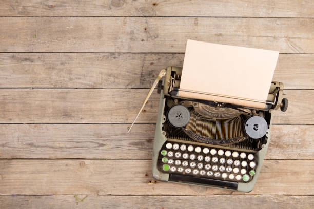 istock Vintage typewriter on the old wooden desk 1154755116