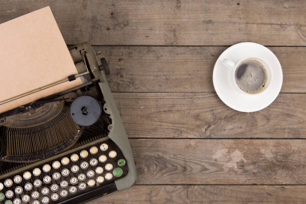 istock Vintage typewriter on the old wooden desk 1154755158