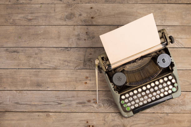 istock Vintage typewriter on the old wooden desk 1154755208