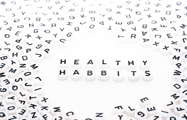 istock Healthy Habits spelled wrong text written with white blocks dice with black text top down view 1154755531