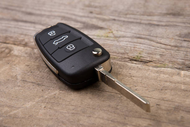 istock Car key with remote alarm control on the wooden desk 1154756535
