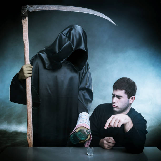 Alcohol is going to kill you Grim reaper encouraging a young man to drink alcohol. cirque de soleil stock pictures, royalty-free photos & images