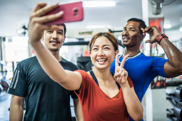 istock Asian friends taking selfie at the gym 1154758380