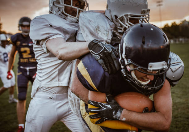 istock Tough American football player making an effort while trying to avoid his opponent. 1154758556