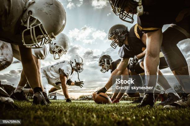 Below View Of American Football Players On A Beginning Of The Match Stock Photo - Download Image Now