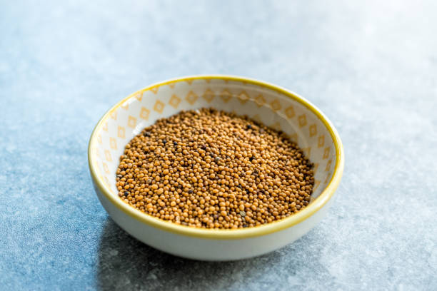istock Yellow Mustard Seeds in Small Porcelain Bowl. 1154759437