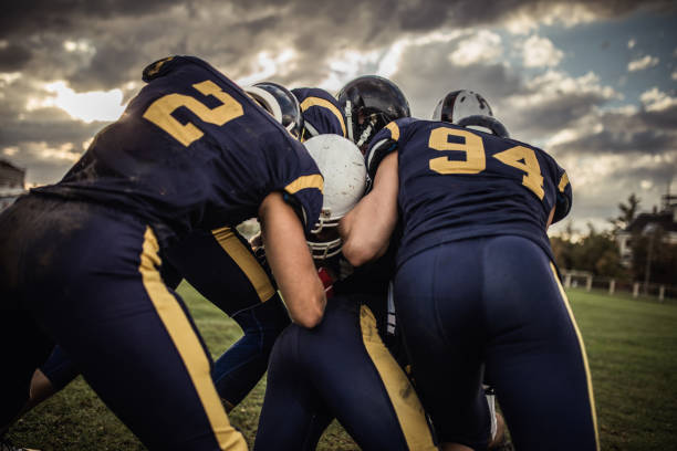 istock American football players blocking opponent player during the game. 1154759788