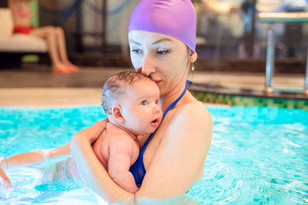 istock Mother swimming with baby in pool 1154759905