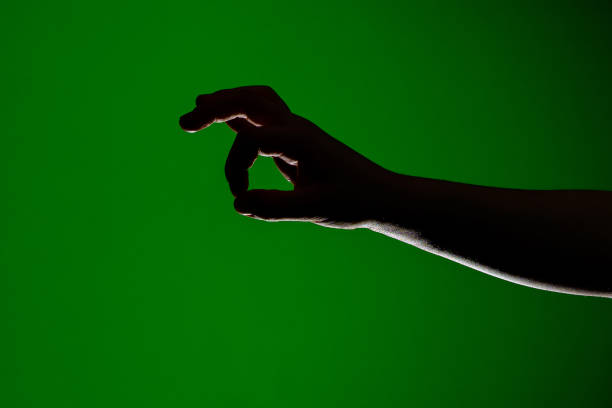 istock Human hand, folded together to take a little small, isolated on a red background 1154760056