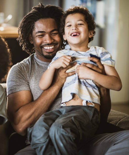 istock Cheerful African American father and son having fun at home. 1154760832