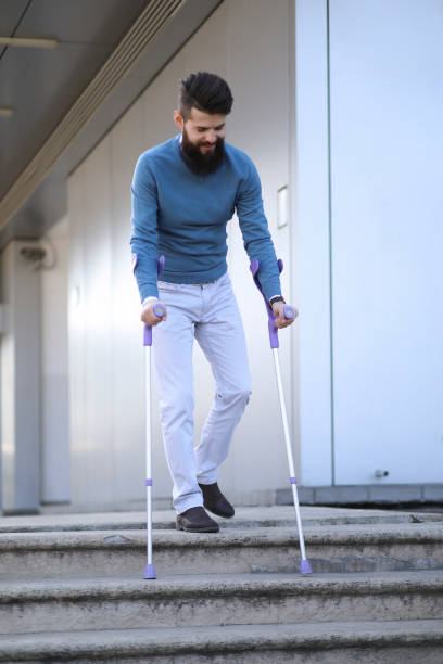 istock Young man with walking sticks outdoors 1154761240