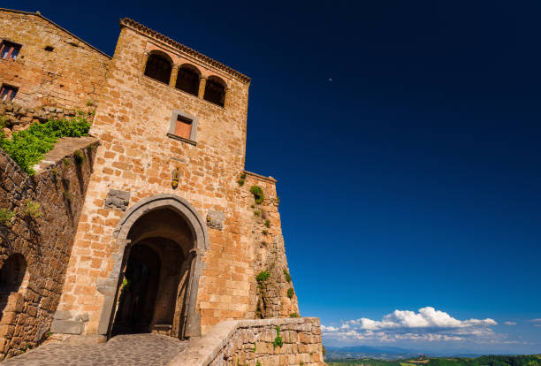 istock Civita di Bagnoregio historic center gate (with blue sky and copy space) 1154761295