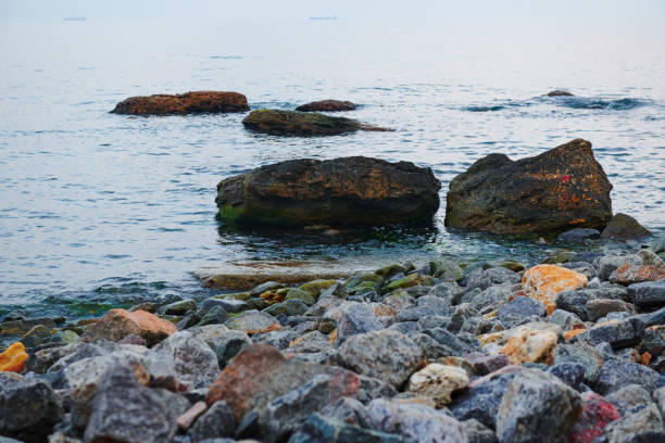 sea landscape at sunset, stone coast and beautiful sky