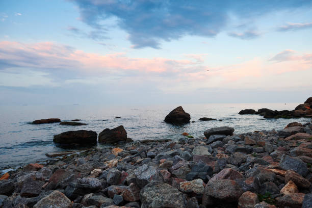 sea landscape at sunset, stone coast and beautiful sky