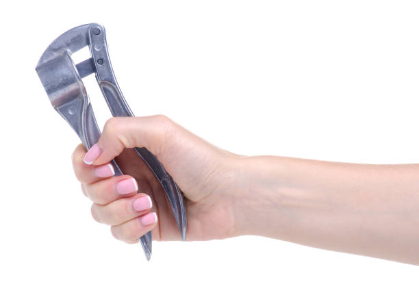 istock Metal press for garlic in hand 1154763798
