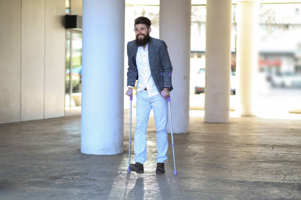istock Young man with walking sticks outdoors 1154763867