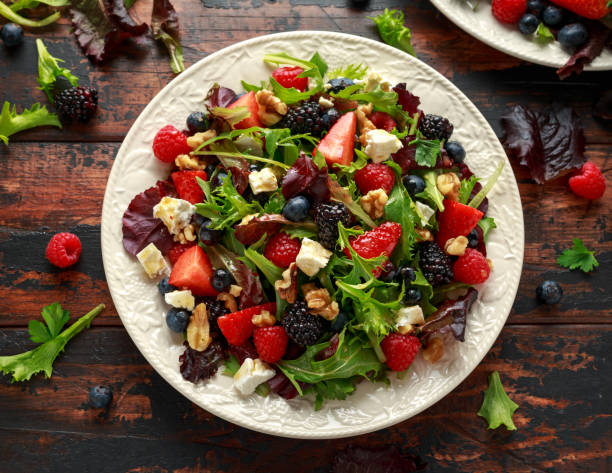 istock Fresh Fruit Salad with blueberry, strawberry raspberry, walnuts, feta cheese and green vegetables. healthy summer food 1154765092