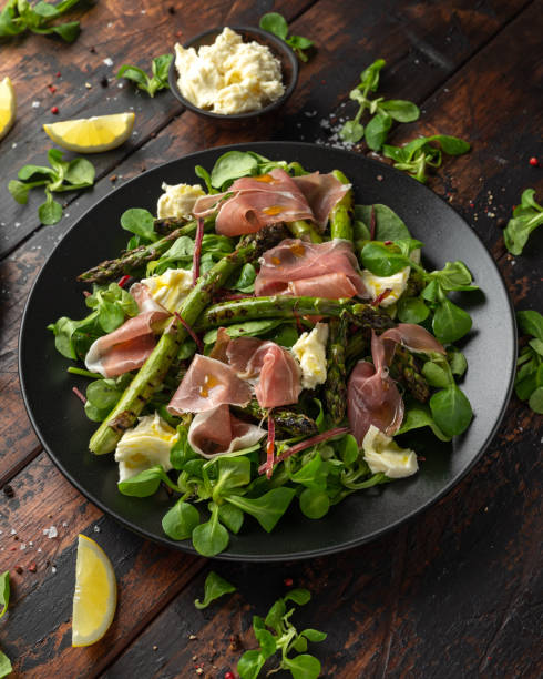 Grilled Asparagus, parma ham salad with mozzarella cheese and green vegetables.