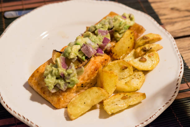istock Salmon Fillet with Avocado in Plate at Dinner Table. 1154765868