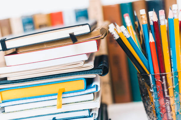 istock Notebooks piles, stack of books education back to school background, textbooks, glasses and pencils in plastic holder with copy space for text 1154765972
