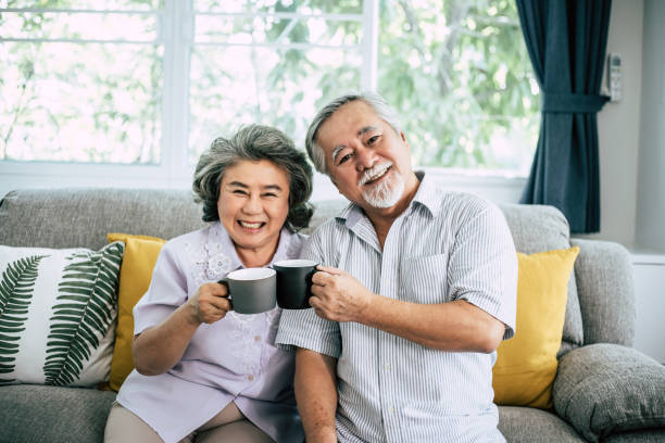 istock Elderly Couple Talking together and drinking coffee or milk 1154766213