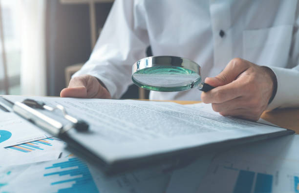 istock Businessman Reading Contract Details Before Signing 1154770118