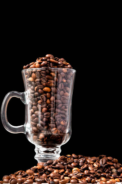istock Black coffee in white cup and coffee beans on black background. Top view, space for text 1154770244