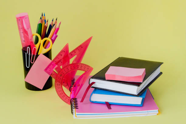 istock Back to school concept with space for text. Copy space. School office supplies.Creative desk with colourful stationery. Colored paper clip.School supplies on yellow background.Office desk 1154771430