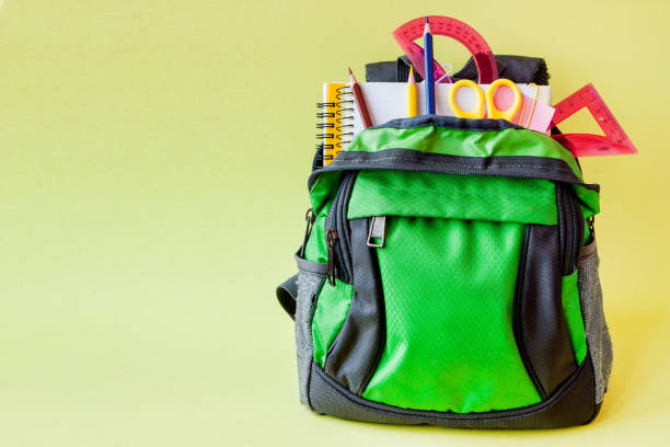 istock Composition with backpack and school stationery on yellow background 1154771649