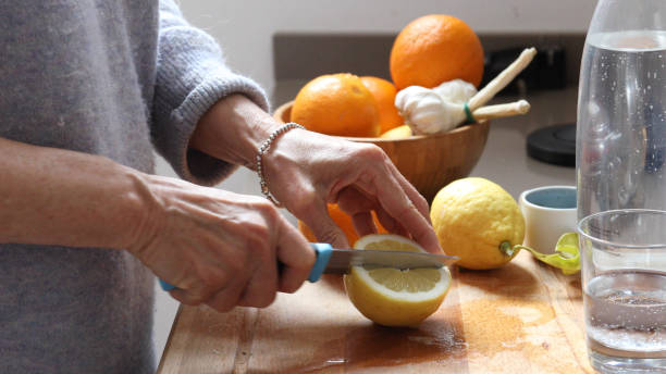 istock woman lemon water kitchen 1154772086