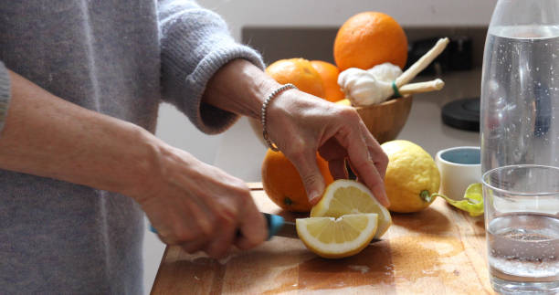 istock woman lemon water kitchen 1154772129