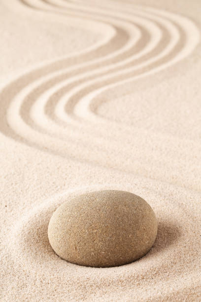 Meditation stone on sand background. stock photo