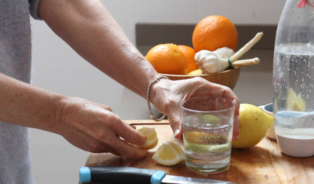 istock woman lemon water kitchen 1154772411