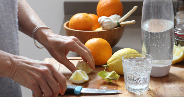 istock woman lemon water kitchen 1154772504