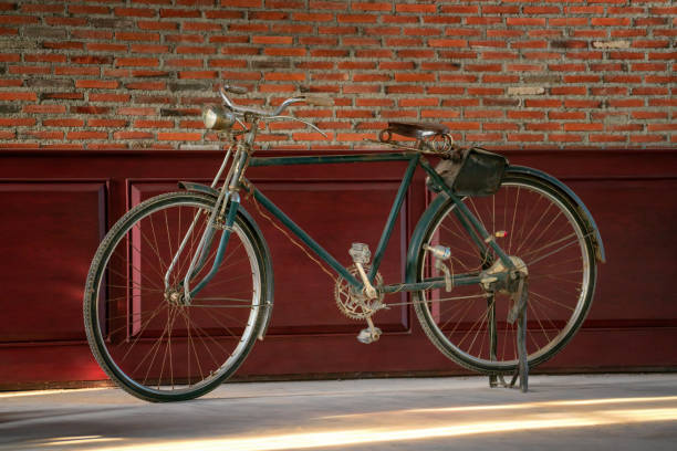 istock Vintage rusted bicycle on wall background. 1154772662