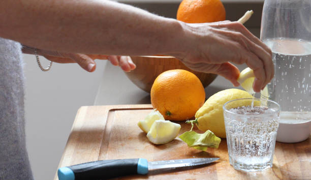 woman lemon water kitchen
