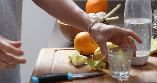 woman lemon water kitchen