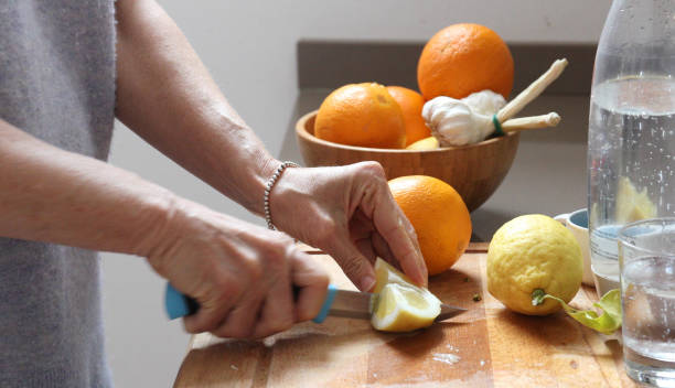 woman lemon water kitchen