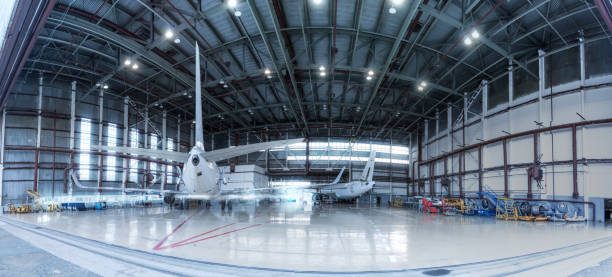 Passenger airplanes under maintenance. Checking mechanical systems for flight operations. Panorama of aircrafts in the hangar