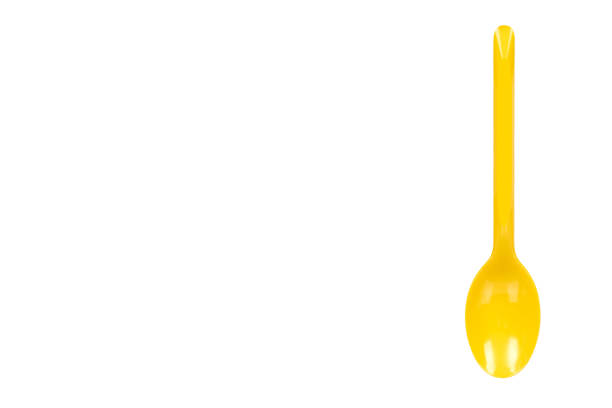 istock Yellow plastic spoon, disposable utensil. Isolated on white 1154774695