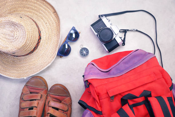istock Backpack and compass and sunglasses and camara and hat and leather shoes spread layout on gray background , travel concept. 1154775097