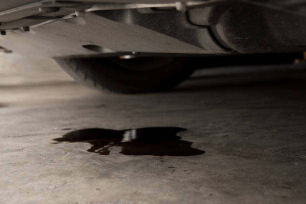 Oil leak or drop from engine of car on concrete floor , check and maintenance auto service Oil leak or drop from engine of car on concrete floor , check and maintenance auto service motor oil photos stock pictures, royalty-free photos & images