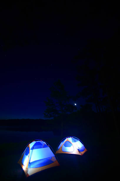 istock Lakeside tent camping with pre-dawn sky reflection 1154776472