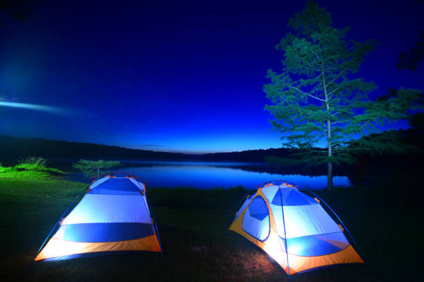 istock Tent camping with pre-dawn sky reflection in lake 1154776519
